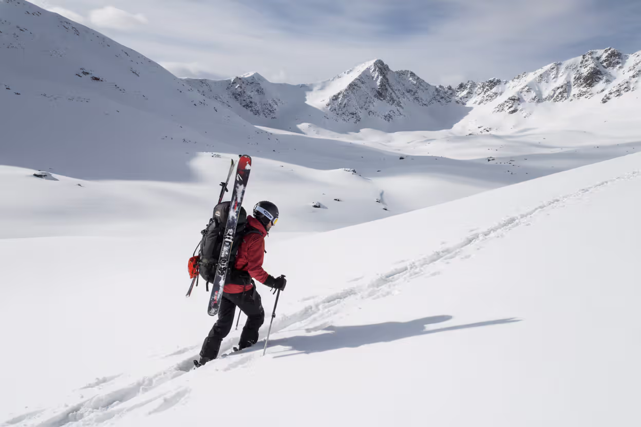 Backcountry skier traversing an unpatrolled snowy slope