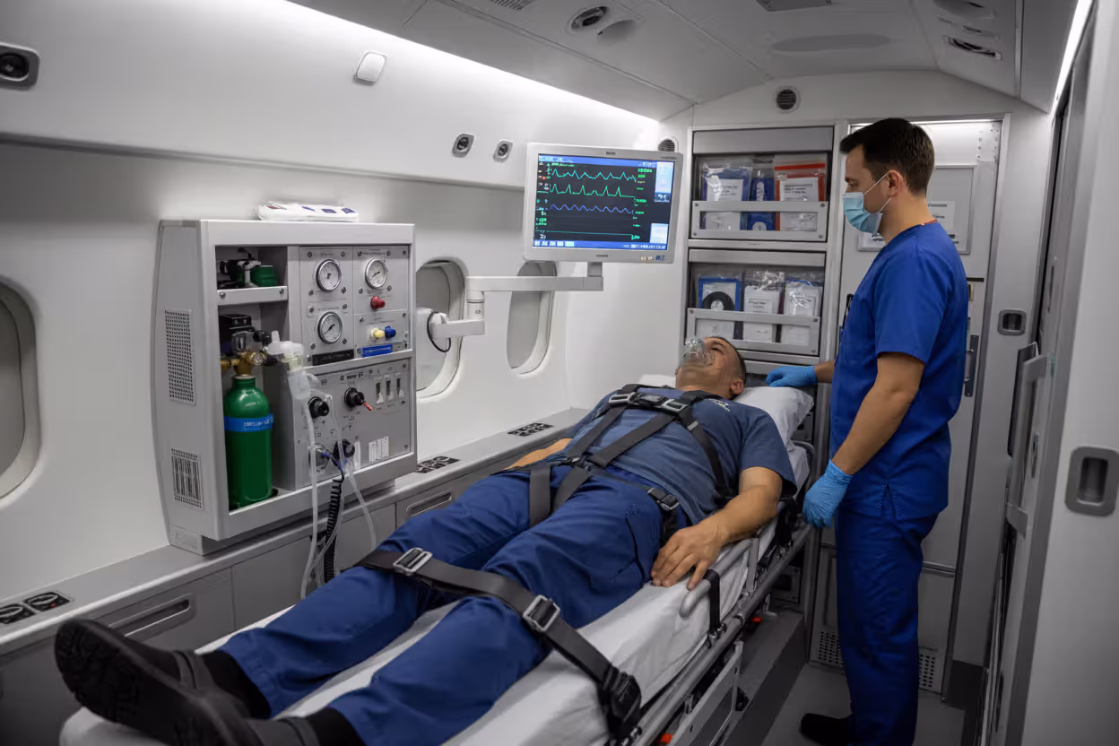 Patient being transported inside an air ambulance with medical staff