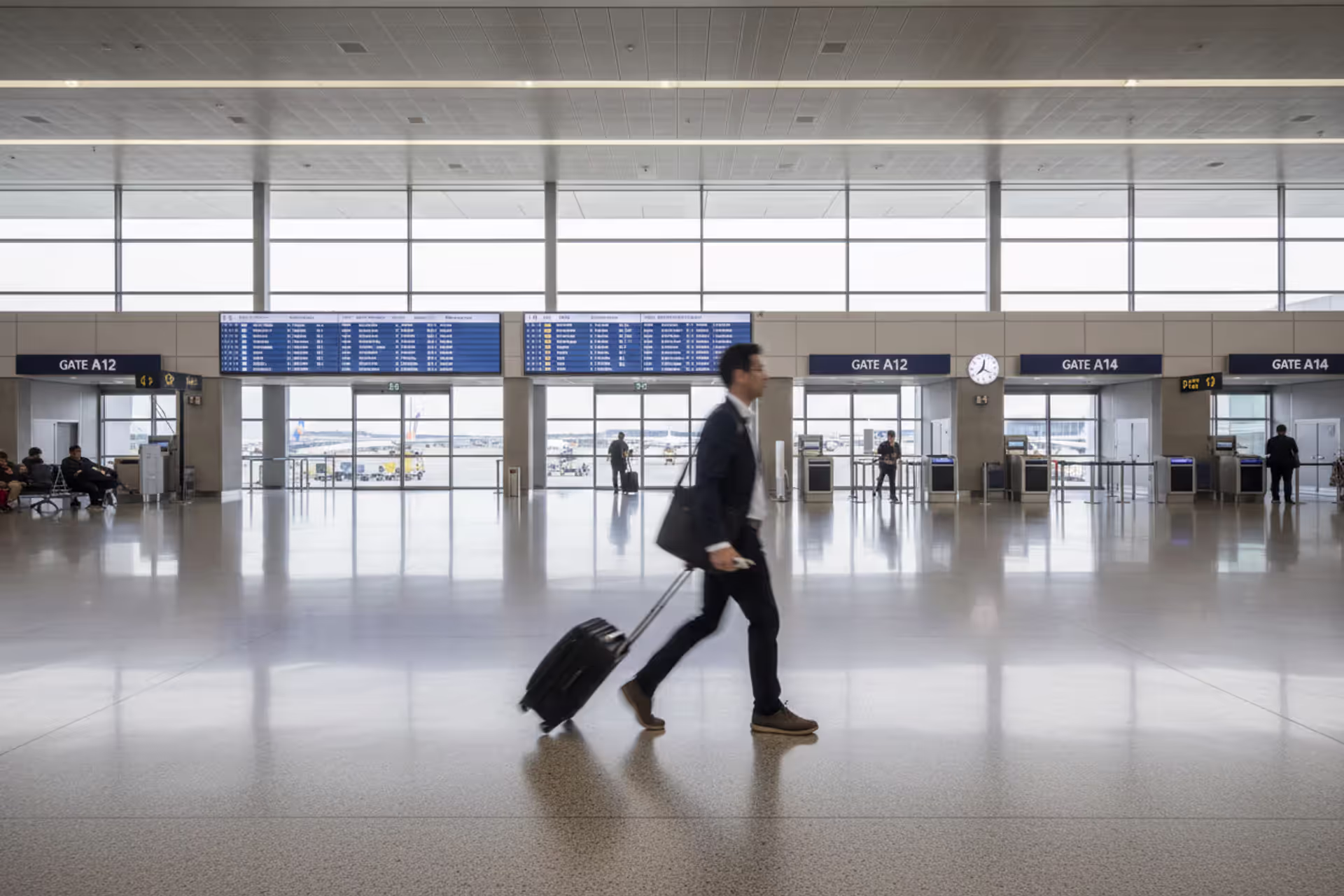 Traveler rushing through an airport terminal toward a departure gate